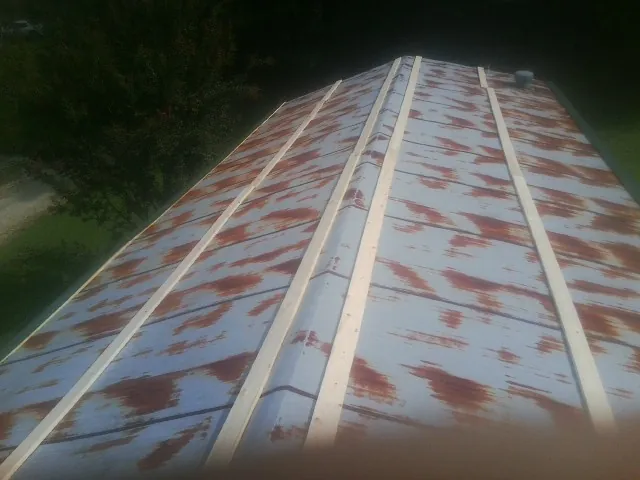 Rusted metal roof panels with new wood purlins before replacement — Storm Damage Roof Repair in Porter by Roofing Brothers
