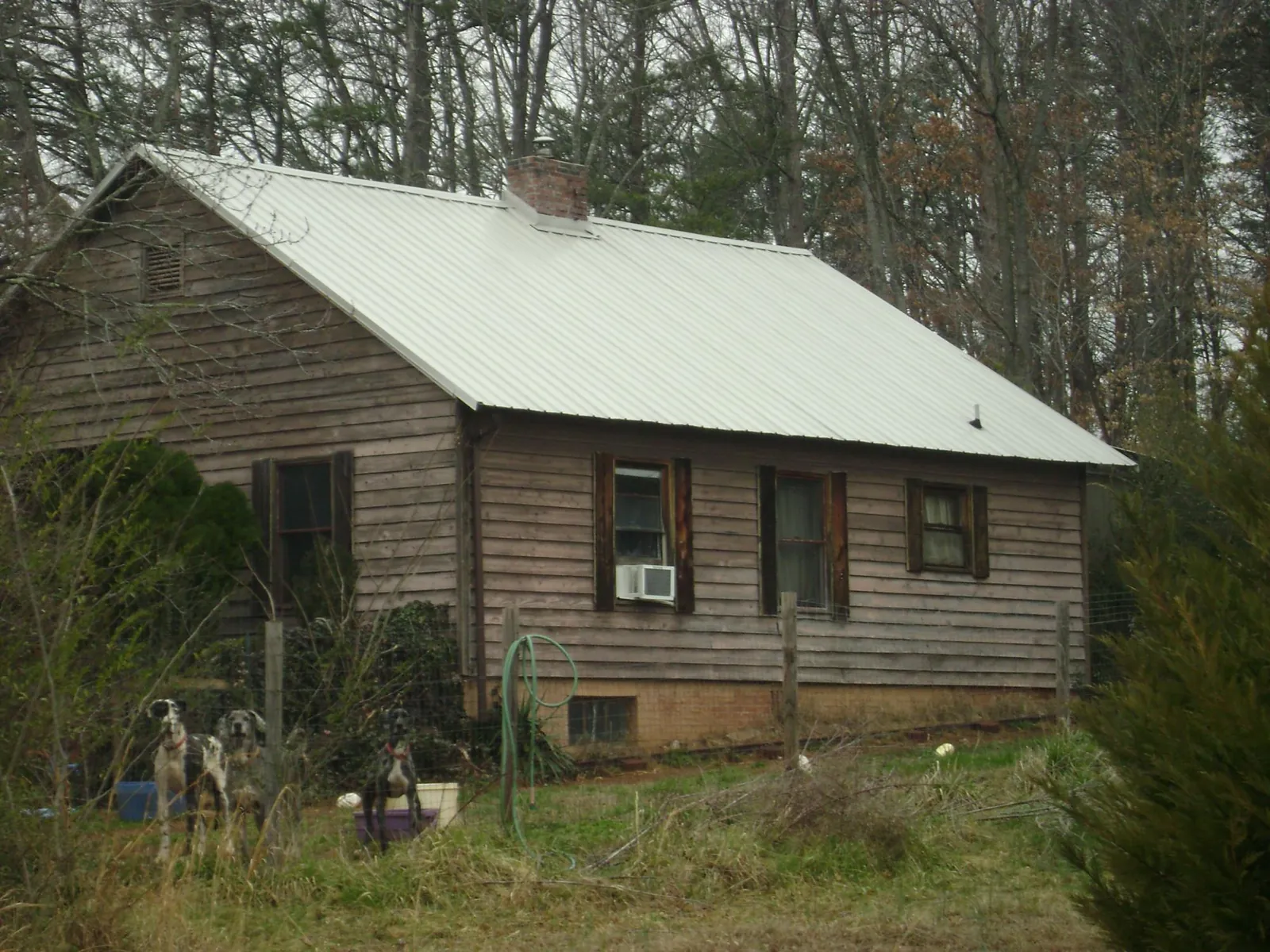 White metal roof on an old wood sided farmhouse, from a Asphalt Shingle Roof Repair job in Porter